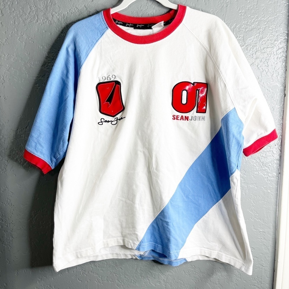 Sean John 1969 01 men size XL/ soft molded plastic covering the numbers shirt.